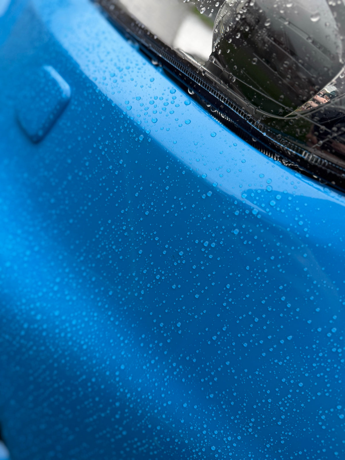 Water beading across a coated bonnet